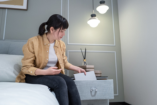 A Chinese woman put her books on the bedside table