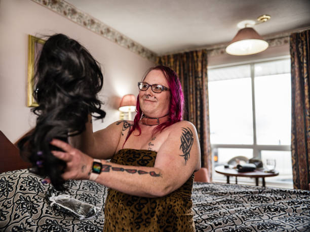 istock Transgender person trying out new wig 1393830975