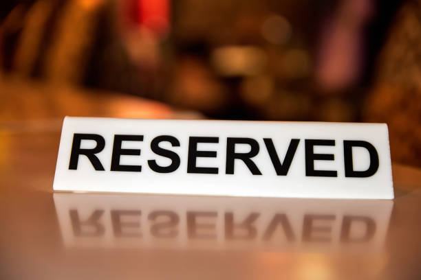 istock Plastic plaque with the inscription Reserved on the restaurant table. 1393832452