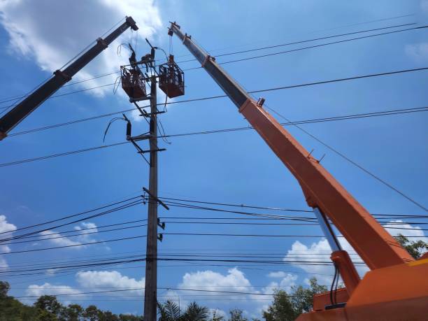 istock electrician on cable car Experienced experts Power lines are being routed along the roadside. 1393833713