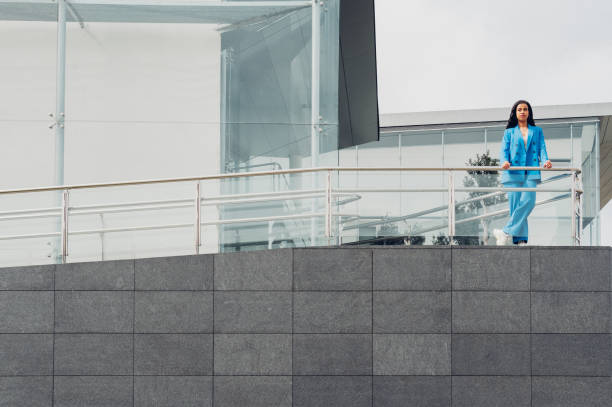 istock Woman leaning on railing in city 1393833849