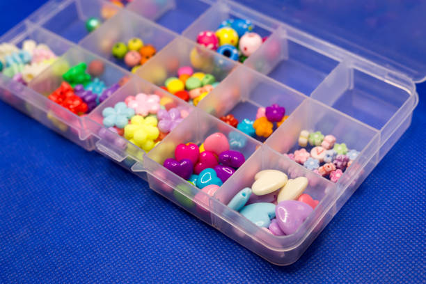 istock Colorful bright accessories for needlework in a plastic box on a blue background 1393834855
