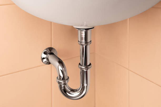istock Bathroom beige interior with sink and metal pipe for draining water 1393834919