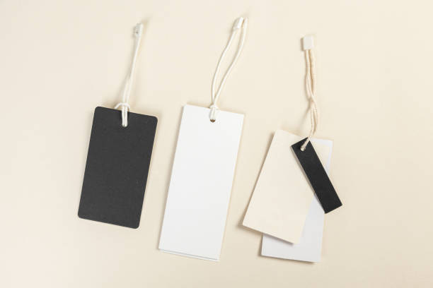 istock Clothing tag, label blank mockup template on a beige background place for text or your logo 1393836194