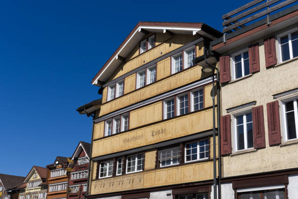 Center of village Urnäsch with beautiful traditional wooden houses. Facades of historic houses at village of Urnäsch on a sunny spring day. Photo taken April 19th, 2022, Urnäsch, Canton Appenzell Ausserrhoden, Switzerland. appenzell ausserrhoden stock pictures, royalty-free photos & images