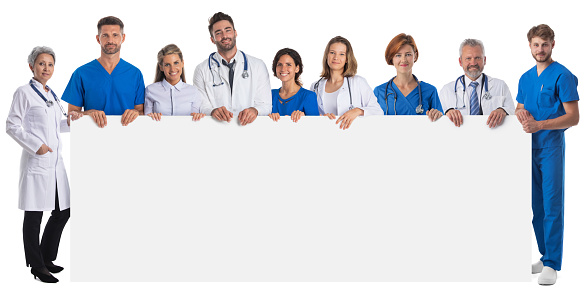 Group of doctors and nurses medical staff with blank banner isolated over a white background, copy space for text content