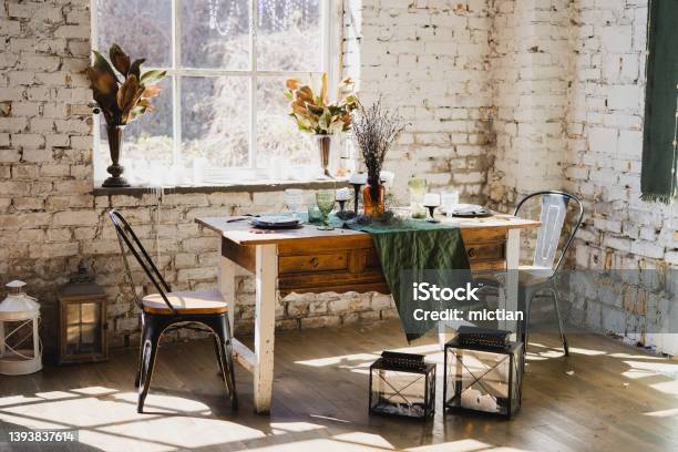 Beautiful Vintage Dining Table With Decorations Flowers Candles And Laying Near The Window Stock Photo - Download Image Now