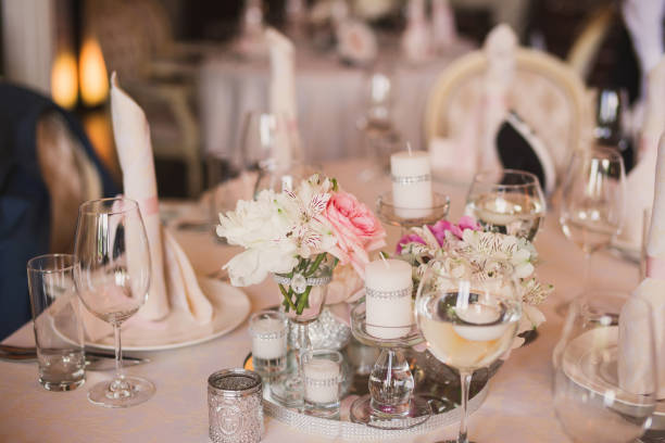 istock Floral compositions and candles on decorated dining table. 1393838519