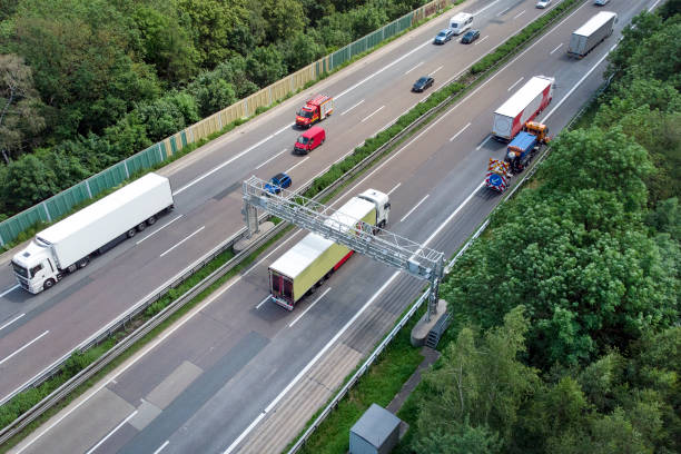 istock Truck toll system on highway - control gantry, aerial view 1393838740