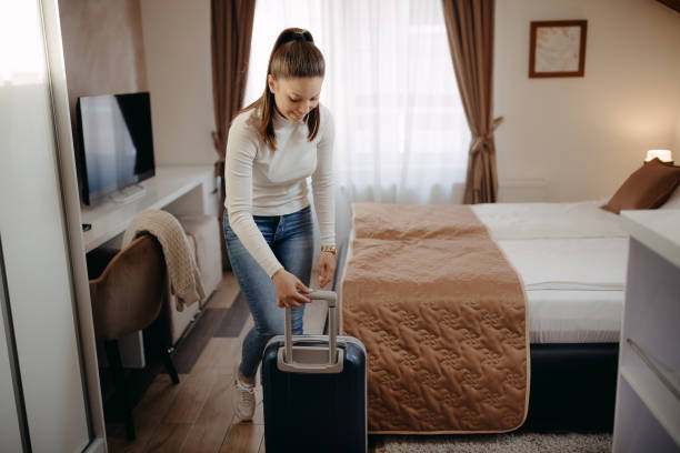 istock Women unpack in the hotel room 1393838754