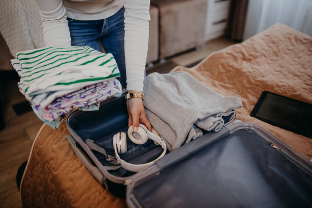 istock Women unpack in the hotel room 1393838796