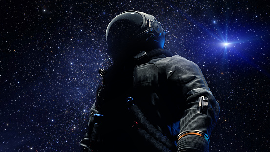 Astronaut in spacesuit helmet is a reflection of stars and galaxies. Space exploration, an astronaut looks up into space. 3d render