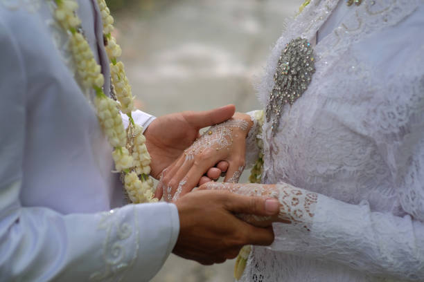 istock Close up of a couple's hands holding each other lovingly 1393844441
