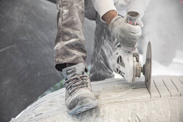 artist who works marble with circular saw stock photo