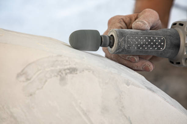 Hands of artist working the marble with an electric chisel stock photo