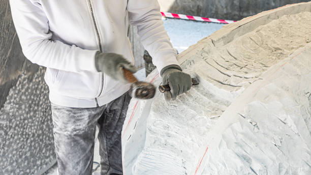 istock Hands of artist who work the marble with hammer and chisel 1393847371