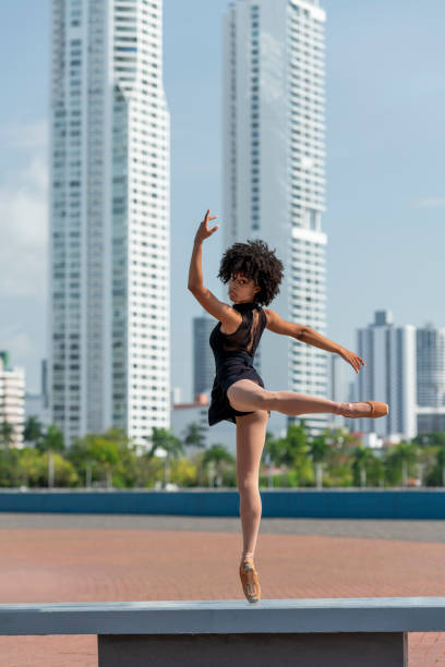 Rear view of latin ballet dancer practicing on street.