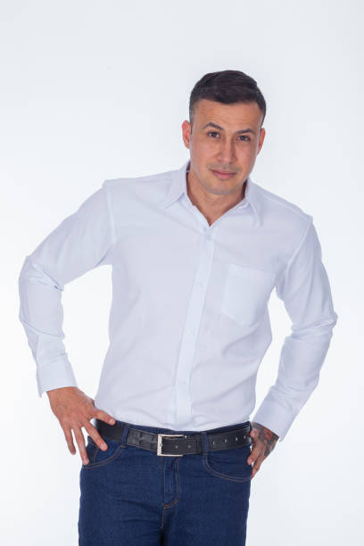 latin man average age 30 from colombia bogota dressed in crew shirt looks up at the camera and smiles