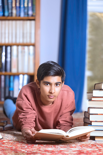 Thirteen-year-old boy of Indian heritage doing some serious revision.
