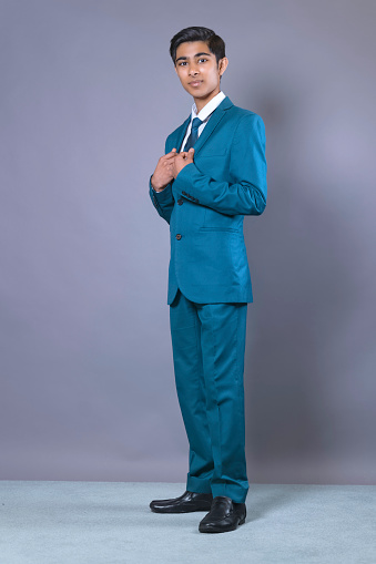 Teenaged youth of Indian heritage wearing a suit and tie.