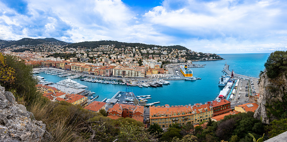 Nice, France - April 3 2022 - Overview of boats waiting for a sail in the Lympia port (porte de Nice Lympia) with very big ship