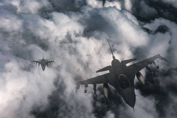istock Jet fighters flying over the clouds. 1393850392