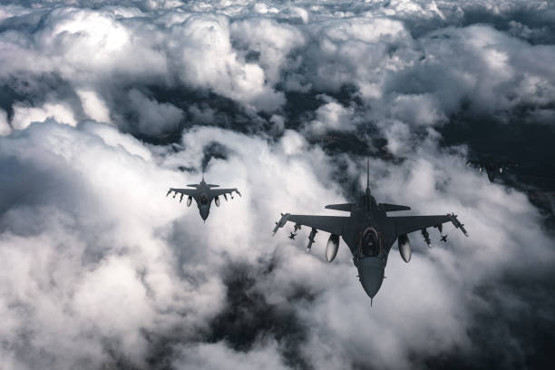 istock Jet fighters flying over the clouds. 1393851186