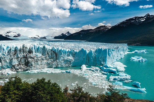 Among the Earth's most dynamic and accessible ice fields, Glaciar Perito Moreno is the stunning centerpiece of the southern sector of Parque Nacional Los Glaciares. Locally referred to as Glaciar Moreno, it measures 30km long, 5km wide and 60m high, but what makes it exceptional in the world of ice is its constant advance – up to 2m per day, causing building-sized icebergs to calve from its face.