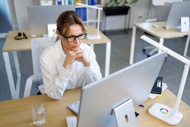 istock Concentrated business woman looking at computer screen 1393851501