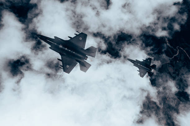istock Jet fighters flying over the clouds. 1393851515