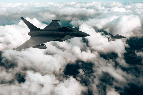 istock Jet fighters flying over the clouds. 1393851535