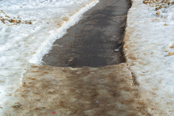 istock pedestrian path partially cleared of ice and snow 1393851617