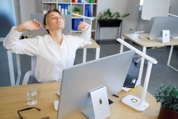 istock Middle aged business woman stretching at workplace in office 1393851698