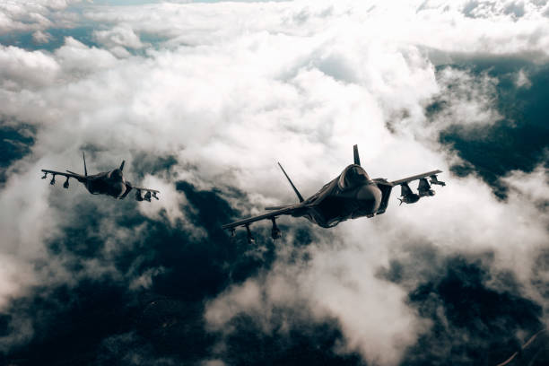 istock Jet fighters flying over the clouds. 1393851740