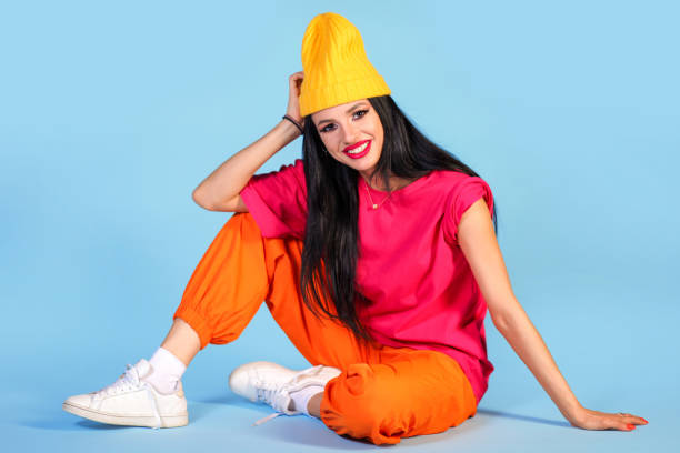 istock Happy young woman sitting on a floor 1393852471