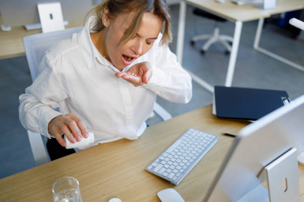 istock Middle aged business woman taking pills at work 1393852752