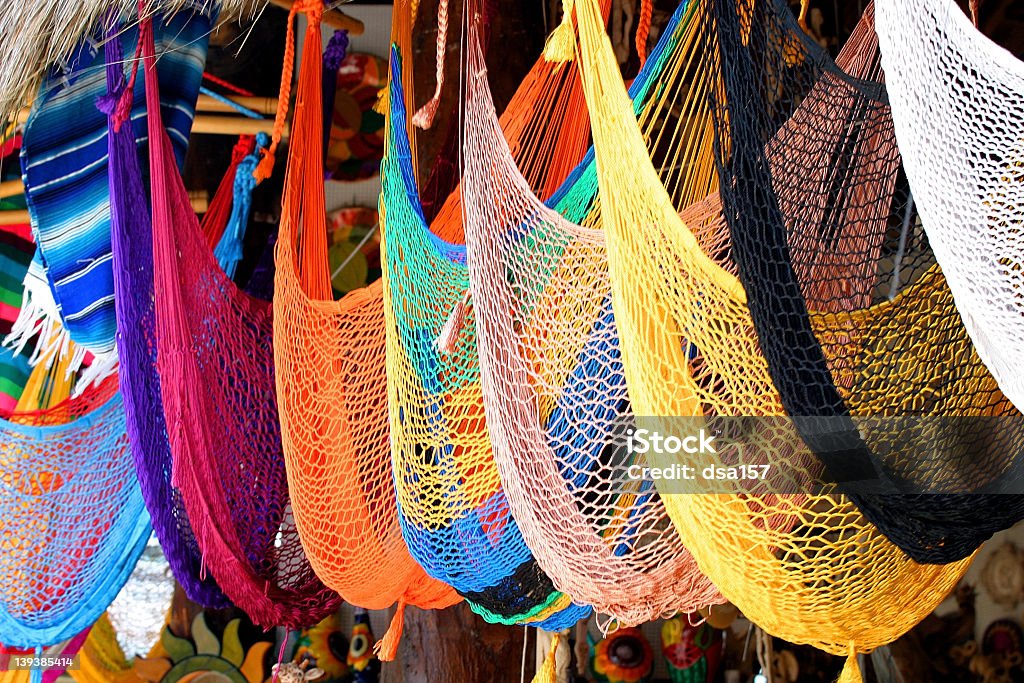 An array of colorful hammocks hanging in a souvenir shop colorful hammocks hang in a Mexican market Hammock Stock Photo
