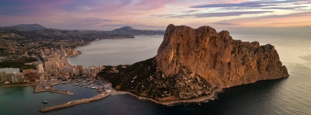 Sunrise over Calpe city and Penyal d Ifac Natural Park stock photo