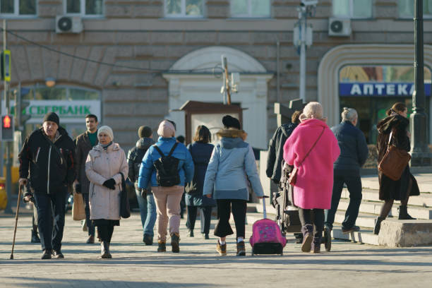 A lot of People on the spring Moscow city street Moscow, Russia - March 17, 2022: Spring cold sunny day. A lot of people. Different generations. russia city spring stock pictures, royalty-free photos & images