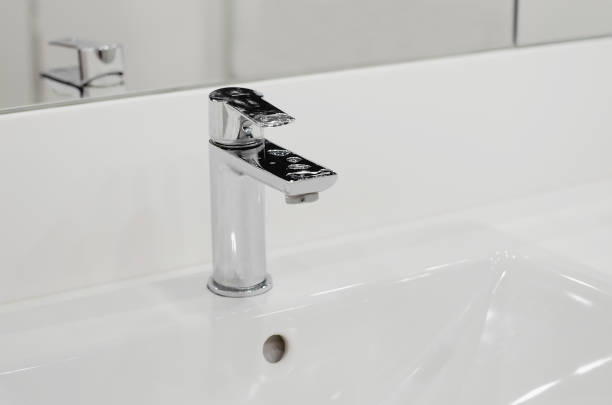 istock modern and clean bathroom sink. Close-up, selective focus. Modern bathroom interior. 1393857394