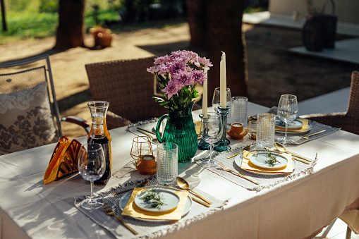 Calm place.An outdoor table set for a dinner party is ready for guests to arrive