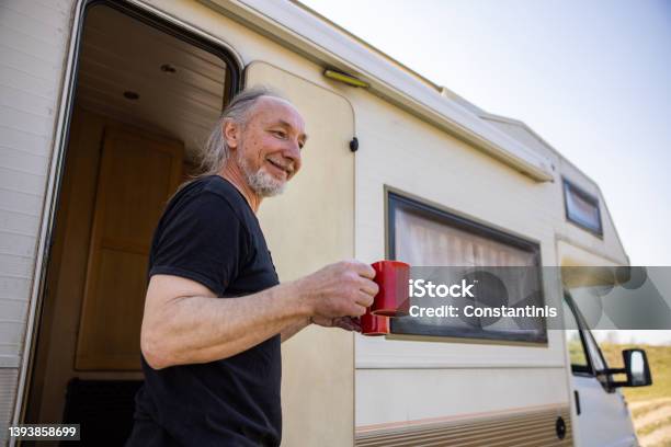 Caucasian Man Holding Cup Of Coffee During Picnic Time With Hic Camper Van Stock Photo - Download Image Now