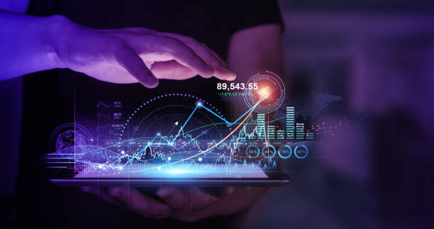 istock Businessman holding tablet with growing virtual hologram of statistics, graph and chart.  Investment of growth on currency rate.Business strategy development and growing growth plan. 1393861932