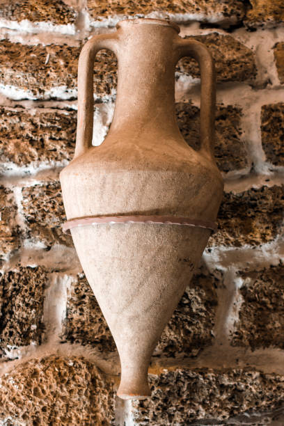 istock An old jug hangs on the wall. Historical things 1393862986