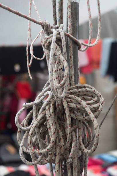 Thick ropes tied in knots. Vertical close-up.