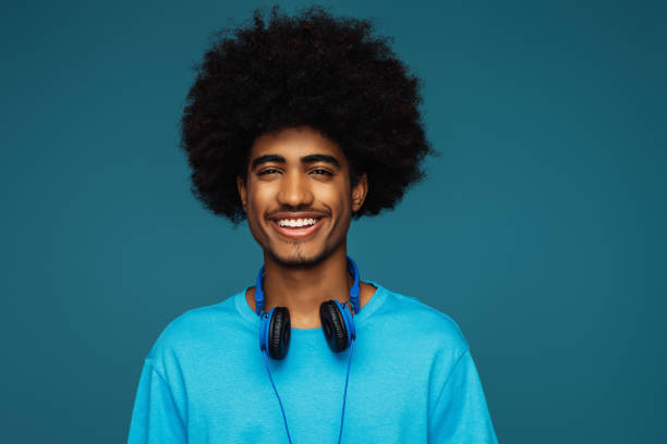 istock African american man with african hairstyle using phone 1393871963