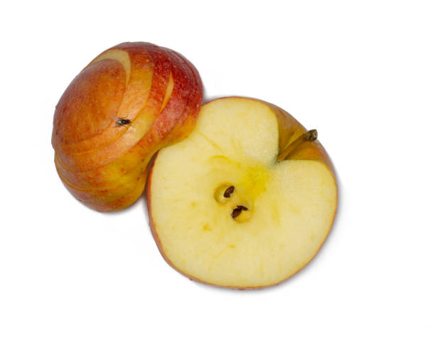istock A large red apple cut into wedges. Fresh fruit isolate. A fly sits on an apple. Half of the fruit is cut. 1393876308