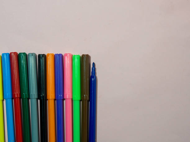 istock multicolored markers on a pink background. Creative atmosphere.  One marker without cap. 1393876377