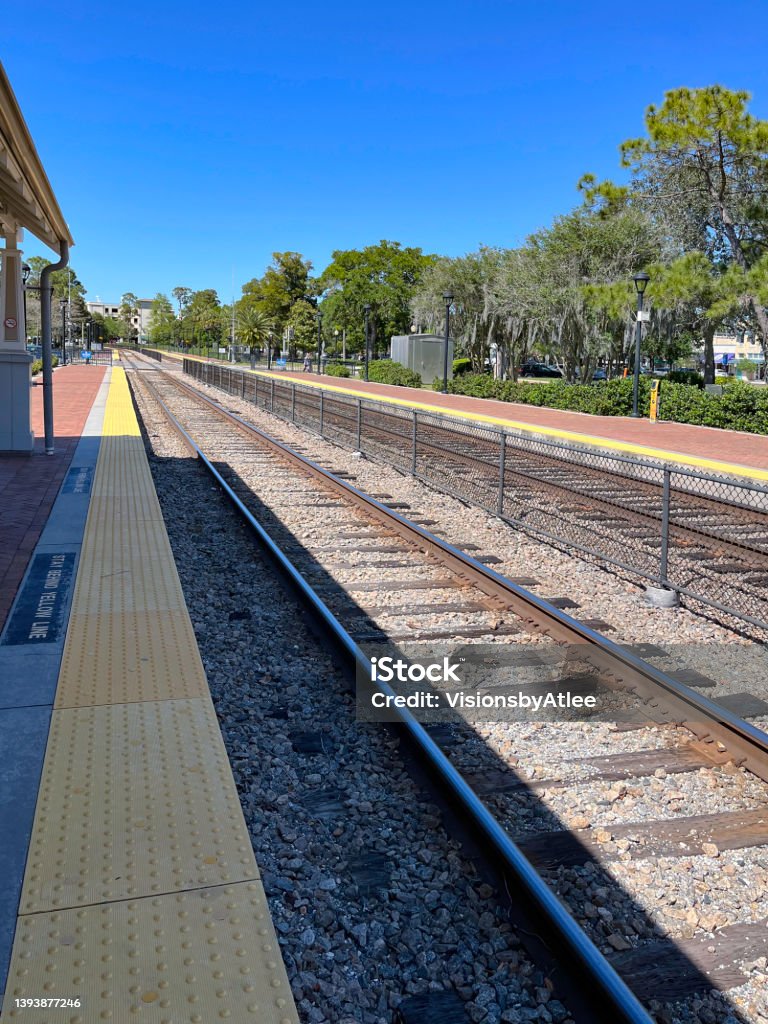 Bricked commuter rail station platform located on a double tracked line at Winter Park, Florida which serves interstate rail travelers, also. Architecture Stock Photo