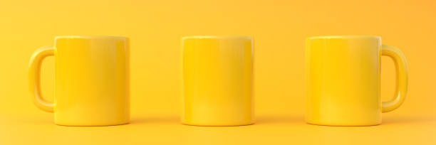 istock Three yellow ceramic cup or empty mug for coffee, drink or tea on yellow background 1393877309